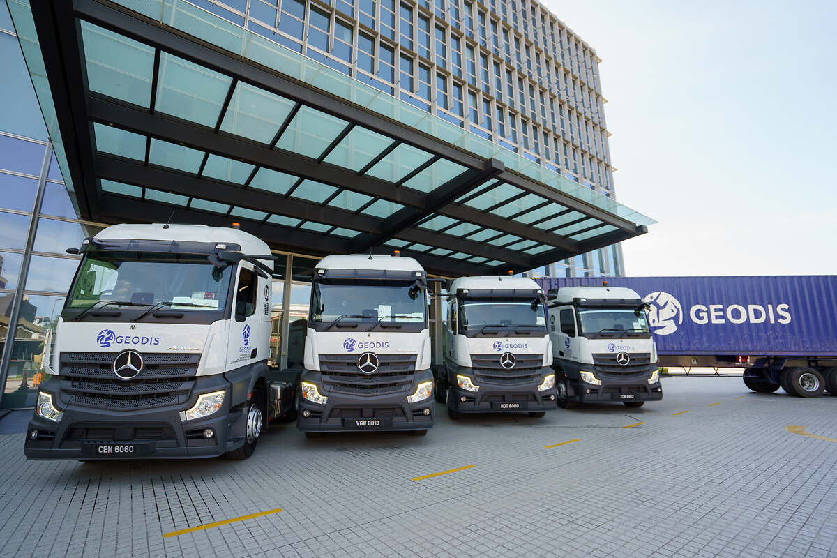 Four trucks in front of a building