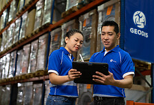 Two employee working on tablet in a warehouse