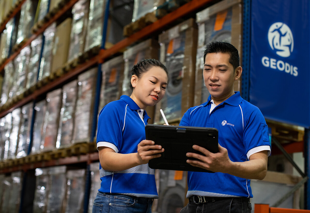 Two employee working on tablet in a warehouse