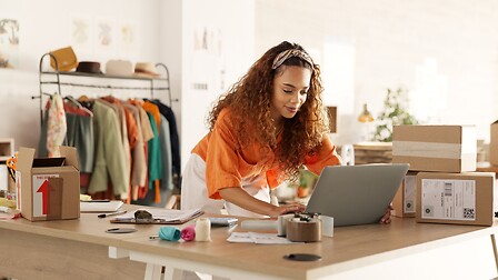 Woman on computer optimizing logistics outsourcing