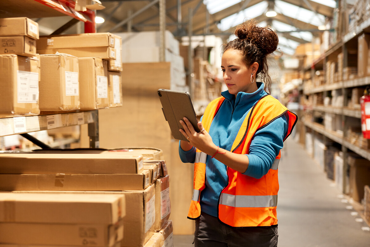 Woman with clipboard looking at and auditing products