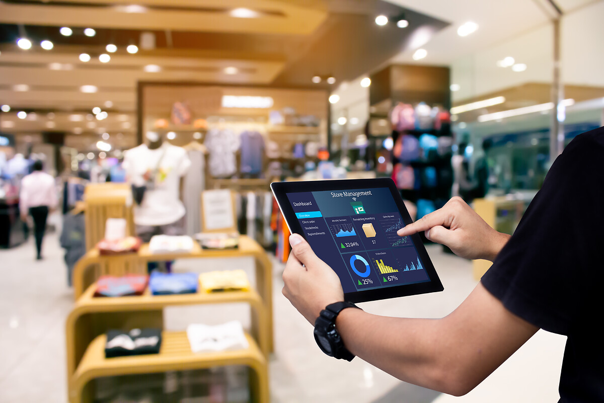 Person using a tablet to monitor retail performance