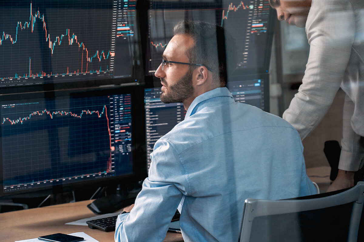 man in front of his computer looking for data