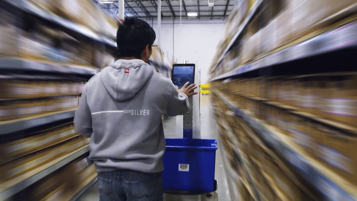 man with picking robot in warehouse