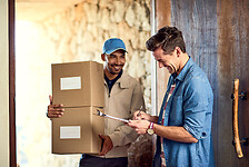 man receiving parcel at home