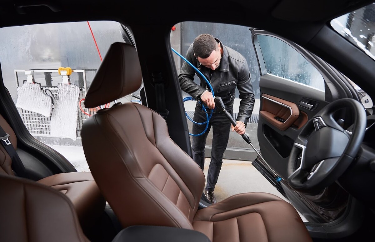 Man washing the interior of a car