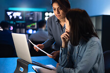 Multiracial female brokers share knowledge about financial investments in stock market.