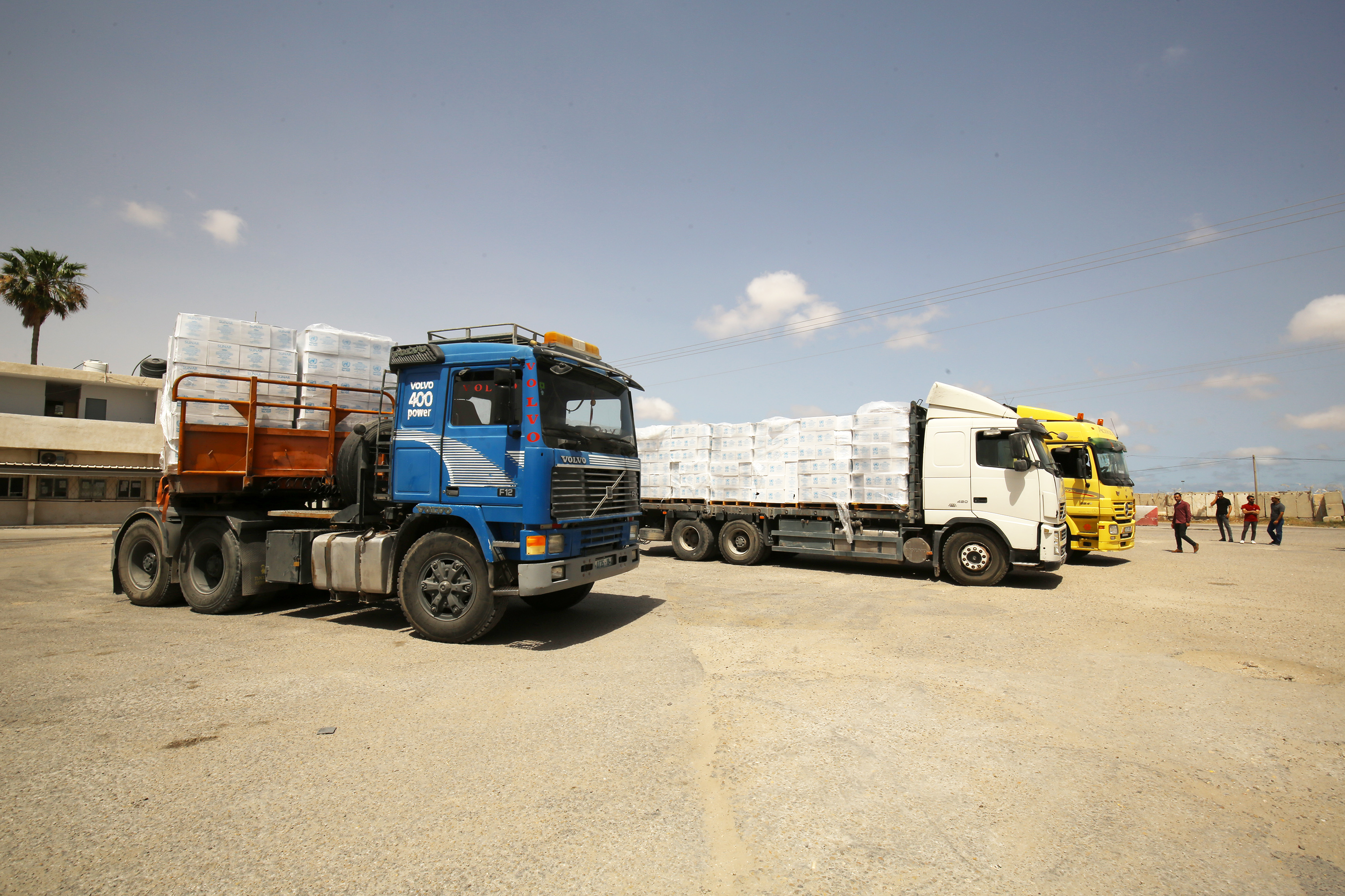 three-trucks-with-human-aid.png