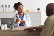 Pharmacist with bottle of medication