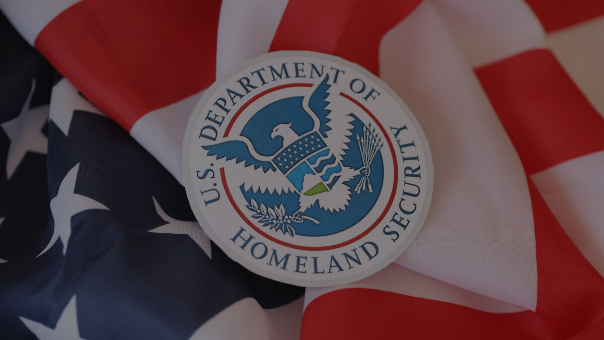 US Department of Homeland Security seal on United States of America flag close up