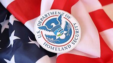 US Department of Homeland Security seal on United States of America flag close up