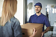 delivery-man-handing-box-to-woman-2024-12-04-03-51-57-utc