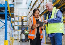 woman and man employees discussing with a tablet in a logistic Freight Forwarding warehouse.jpg
